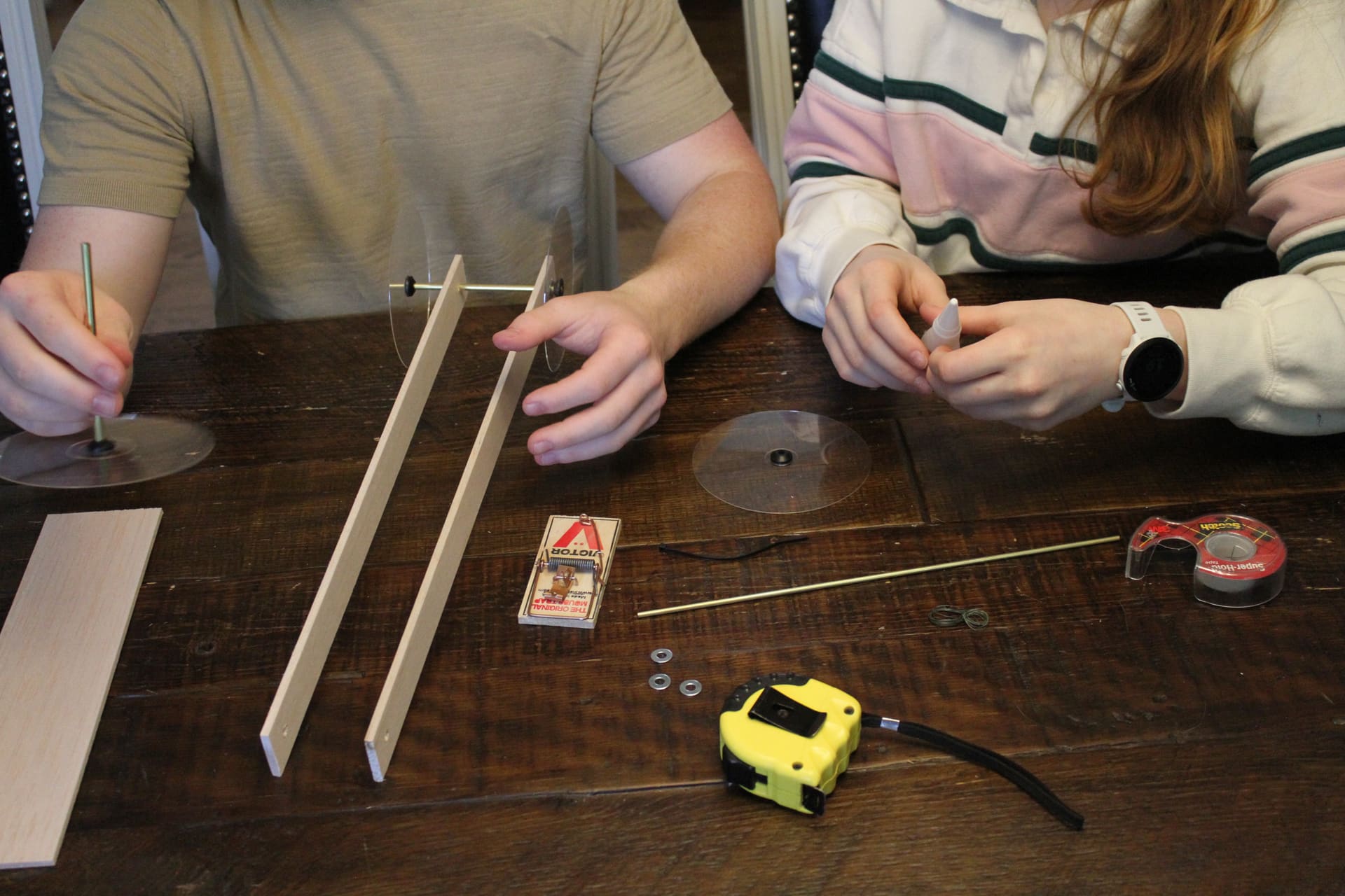 Students building a mousetrap car